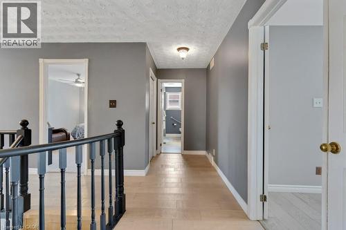 Corridor featuring an upstairs landing, a textured ceiling, and light wood-style floors - 148 Cowan Boulevard, Cambridge, ON - Indoor Photo Showing Other Room