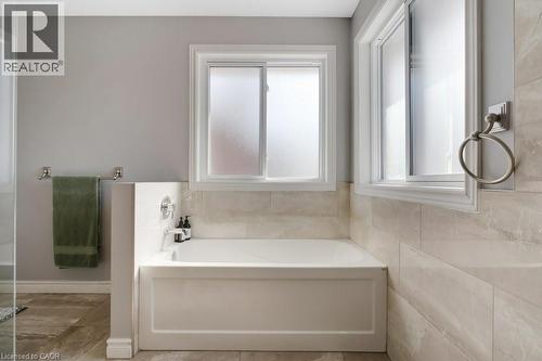 Bathroom with a bath and baseboards - 148 Cowan Boulevard, Cambridge, ON - Indoor Photo Showing Bathroom