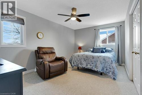 Bedroom with light colored carpet, a ceiling fan, and a closet - 148 Cowan Boulevard, Cambridge, ON - Indoor Photo Showing Bedroom