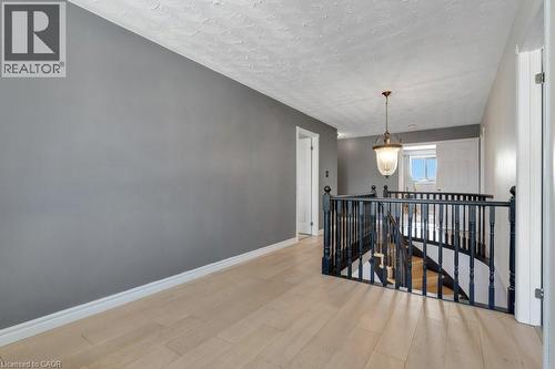 Hallway featuring an upstairs landing, light wood-style flooring, and a textured ceiling - 148 Cowan Boulevard, Cambridge, ON - Indoor Photo Showing Other Room
