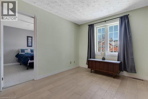 Spare room featuring light wood-style floors and a textured ceiling - 148 Cowan Boulevard, Cambridge, ON - Indoor