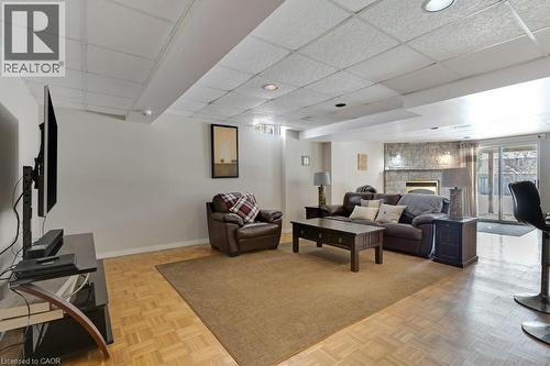 Living area with a paneled ceiling, a fireplace, and parquet floors - 148 Cowan Boulevard, Cambridge, ON - Indoor