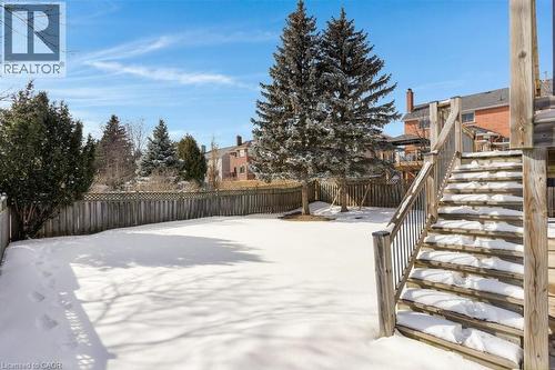 Yard covered in snow featuring stairs and a fenced backyard - 148 Cowan Boulevard, Cambridge, ON - Outdoor
