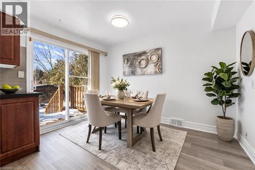 Fresh paint, new flooring, walk out to backyard (virtual staged) - 40 West 3Rd Street, Hamilton, ON - Indoor Photo Showing Dining Room