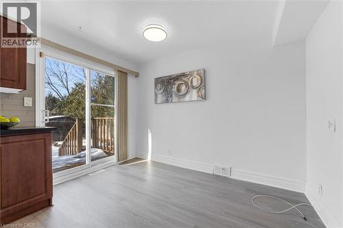 Fresh paint, new flooring, walk out to backyard - 40 West 3Rd Street, Hamilton, ON - Indoor Photo Showing Other Room