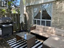 Wooden deck with area for grilling, outdoor lounge area, and fence - 