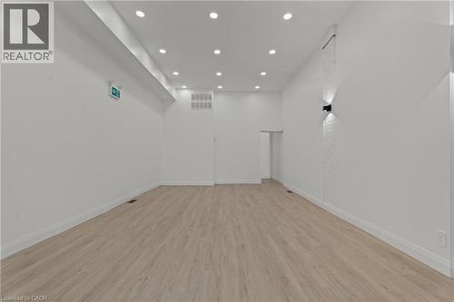 Spare room featuring light wood-style floors and recessed lighting - 93 John Street S, Hamilton, ON 