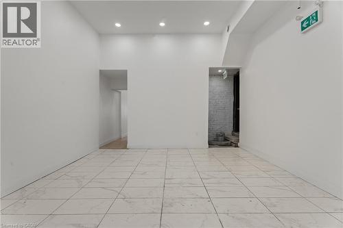 Empty room featuring recessed lighting and light marble finish floors - 93 John Street S, Hamilton, ON 