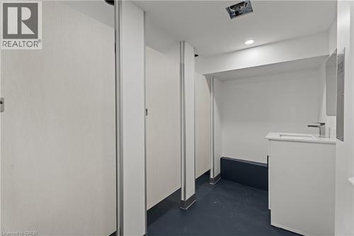 Corridor with concrete floors and recessed lighting - 93 John Street S, Hamilton, ON 