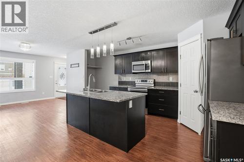 116 125 Willis Crescent, Saskatoon, SK - Indoor Photo Showing Kitchen With Upgraded Kitchen