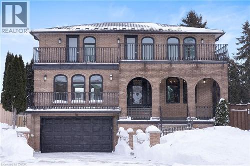View of front of house with brick siding, a garage, covered porch, and a balcony - 16 Bosna Court, Hamilton, ON - Outdoor