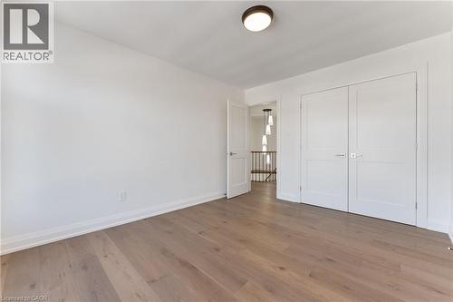 Unfurnished bedroom with wood finished floors and a closet - 16 Bosna Court, Hamilton, ON - Indoor Photo Showing Other Room