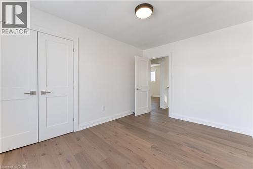 Unfurnished bedroom featuring light wood-style floors and a closet - 16 Bosna Court, Hamilton, ON - Indoor Photo Showing Other Room