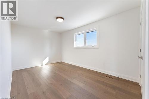 Spare room with hardwood / wood-style flooring and baseboards - 16 Bosna Court, Hamilton, ON - Indoor Photo Showing Other Room