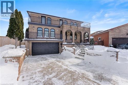 Mediterranean / spanish home featuring brick siding, an attached garage, concrete driveway, and a balcony - 16 Bosna Court, Hamilton, ON - Outdoor