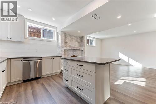 Kitchen featuring light wood-style flooring, stainless steel dishwasher, a center island, open floor plan, and recessed lighting - 16 Bosna Court, Hamilton, ON - Indoor Photo Showing Kitchen
