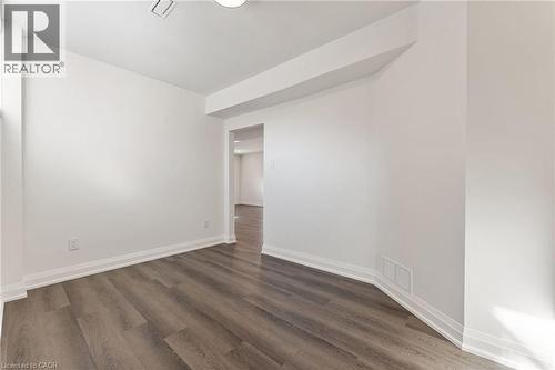 Spare room featuring dark wood-type flooring - 16 Bosna Court, Hamilton, ON - Indoor Photo Showing Other Room