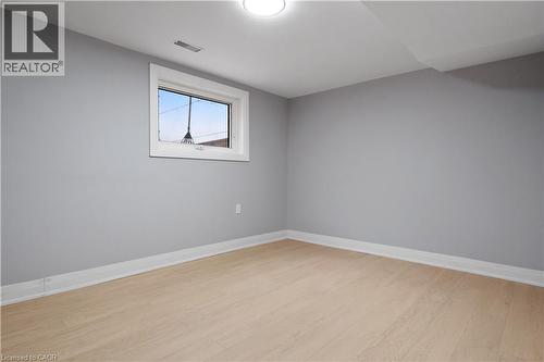 Spare room featuring baseboards and light wood-style flooring - 19 Broad Street, Brantford, ON - Indoor Photo Showing Other Room