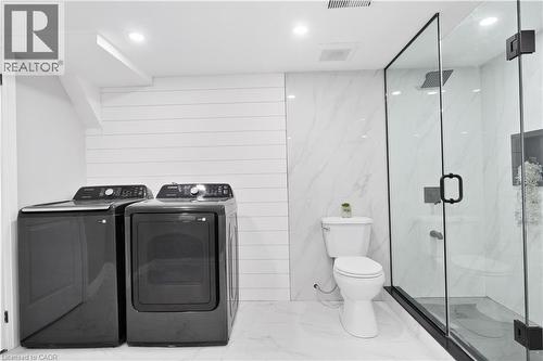 Bathroom with a marble finish shower, marble tiled flooring, washing machine and dryer, and recessed lighting - 19 Broad Street, Brantford, ON - Indoor Photo Showing Laundry Room