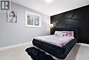 Bedroom with a decorative wall, light wood-type flooring, and an accent wall - 19 Broad Street, Brantford, ON  - Indoor Photo Showing Bedroom 