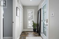 Light-filled, open foyer with tile floors & closet - 