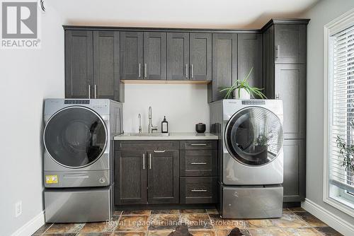 Built ins & quartz counters in main floor laundry - 19 Trails End, Collingwood, ON 