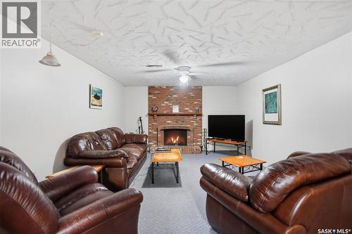 64 Craigie Bay, Regina, SK - Indoor Photo Showing Living Room With Fireplace