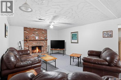 64 Craigie Bay, Regina, SK - Indoor Photo Showing Living Room With Fireplace