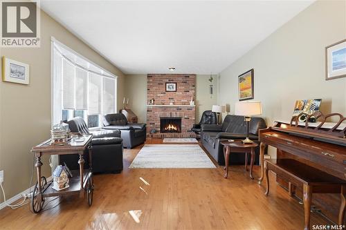 64 Craigie Bay, Regina, SK - Indoor Photo Showing Living Room With Fireplace