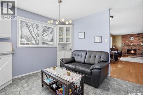 64 Craigie Bay, Regina, SK - Indoor Photo Showing Living Room With Fireplace