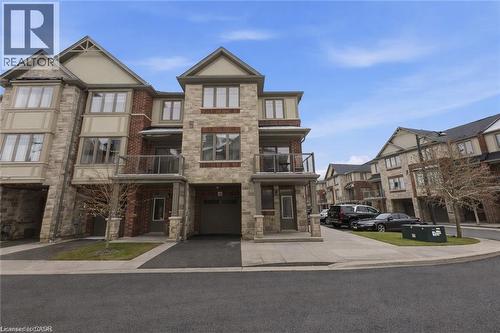 View of building exterior featuring a garage and asphalt driveway - 4 Andruss Lane, Ancaster, ON - Outdoor With Facade