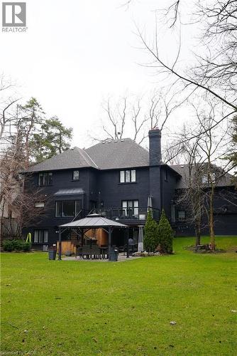Rear view of property featuring a yard, a chimney, and a patio area - 1436 Crescent Road, Mississauga, ON - Outdoor With Deck Patio Veranda