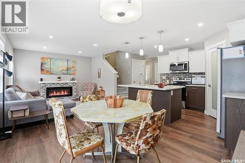 474 Schmeiser Bend, Saskatoon, SK - Indoor Photo Showing Dining Room With Fireplace