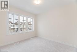 Unfurnished room featuring carpet flooring - 