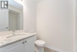 Bathroom with walk in shower, tile patterned floors, toilet, and vanity - 