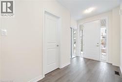 Foyer entrance with light hardwood / wood-style floors - 