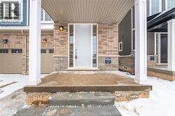 Snow covered property entrance with a garage - 