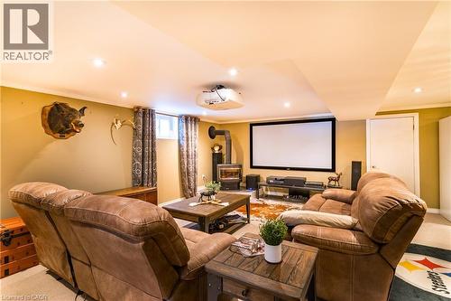 Spacious family room with cozy gas fireplace and 92"" entertainment station - 102 Greeningdon Drive, Hamilton, ON - Indoor