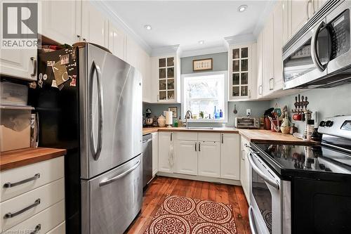 Kitchen featuring white cabinets, appliances with stainless steel finishes, and wooden counters - 40 Locke Street S, Hamilton, ON - Indoor Photo Showing Kitchen