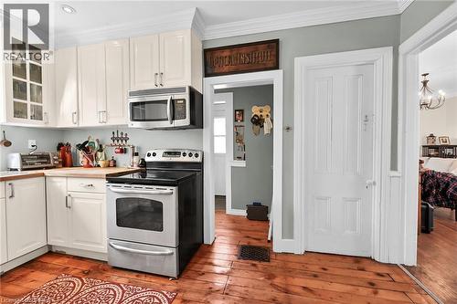 Kitchen featuring appliances with stainless steel finishes, white cabinetry, and light hardwood / wood-style flooring - 40 Locke Street S, Hamilton, ON - Indoor Photo Showing Kitchen