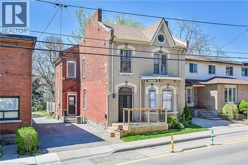 View of front of property featuring central AC unit - 40 Locke Street S, Hamilton, ON - Outdoor With Facade