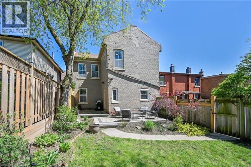 Rear view of property featuring a lawn and a patio area - 40 Locke Street S, Hamilton, ON - Outdoor
