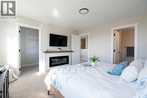 202 Yuel Lane, Saskatoon, SK - Indoor Photo Showing Bedroom With Fireplace
