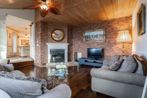Salle familiale - 8940 Boul. Marie-Victorin, Brossard, QC - Indoor Photo Showing Living Room With Fireplace