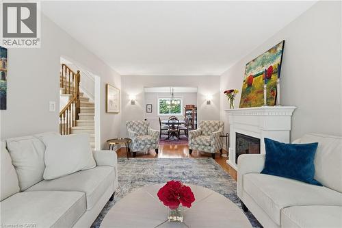 Living room with fireplace and view to dining room - 668 Tomahawk Crescent, Ancaster, ON - Indoor Photo Showing Living Room With Fireplace