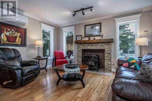 Living room with pellet stove and mini split - 34 Blackstrap Path, Conception Bay South, NL - Indoor Photo Showing Living Room With Fireplace