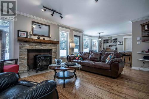 Rooms at back of house open to patio and covered BBQ area - 34 Blackstrap Path, Conception Bay South, NL - Indoor Photo Showing Living Room With Fireplace