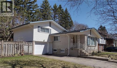 View of front of home with brick siding, an attached garage, and asphalt driveway - 132 Forest Hill Drive, Kitchener, ON - Outdoor