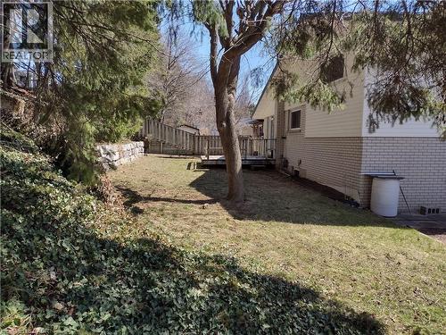 Fenced backyard with a wooden deck - 132 Forest Hill Drive, Kitchener, ON - Outdoor