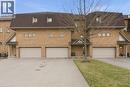 Traditional home with a garage, brick siding, and driveway - 100 Beddoe Drive Unit# 25, Hamilton, ON  - Outdoor With Facade 